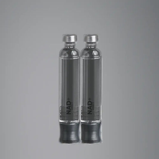 Two clear vials with silver caps on a gray background